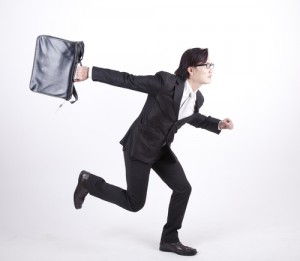 Businessman with briefcase dashing off