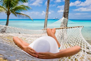 Woman relaxing in a hammock on the beach