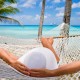 Woman relaxing in a hammock on the beach